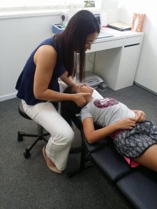 Dr Jenny treating her child patient's neck 2