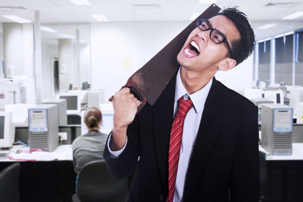a frustrated man putting a saw on his neck