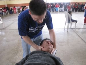 Dr Jeff treating his patient's neck in Peru