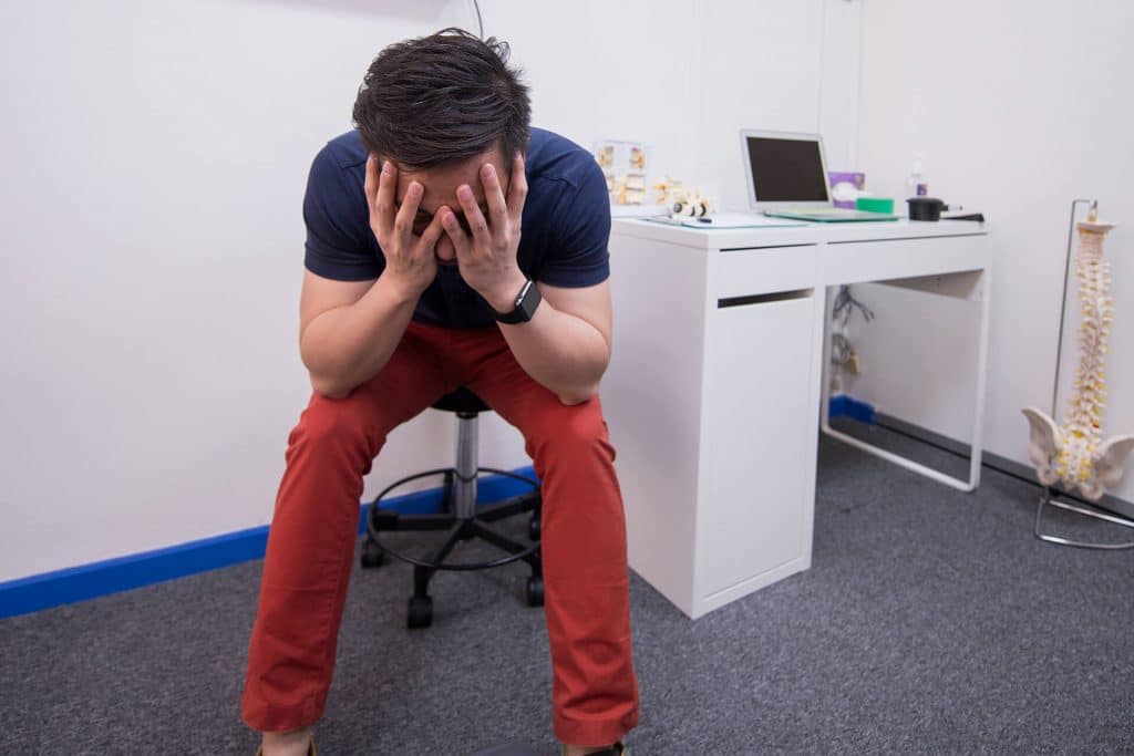 5 Ways to Sabotage Your Back 7 a man stressed out