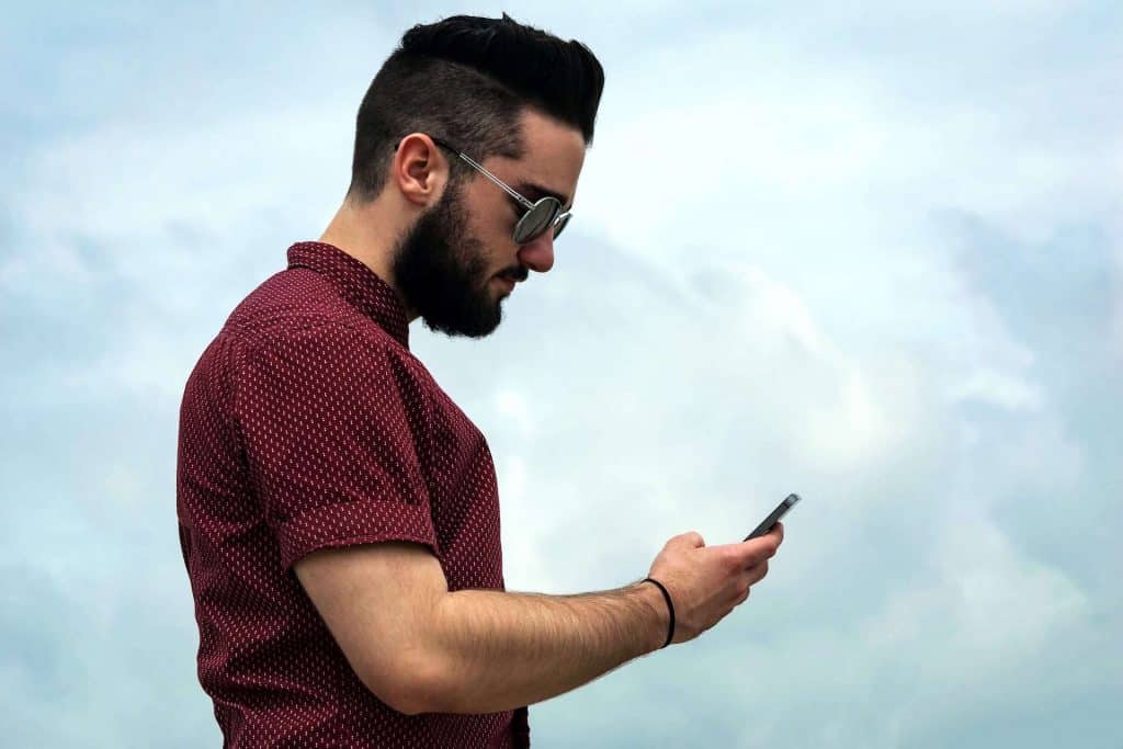 Mobile Phone: The Innocent Back Killer 6 Man holding a Phone and lowering his neck