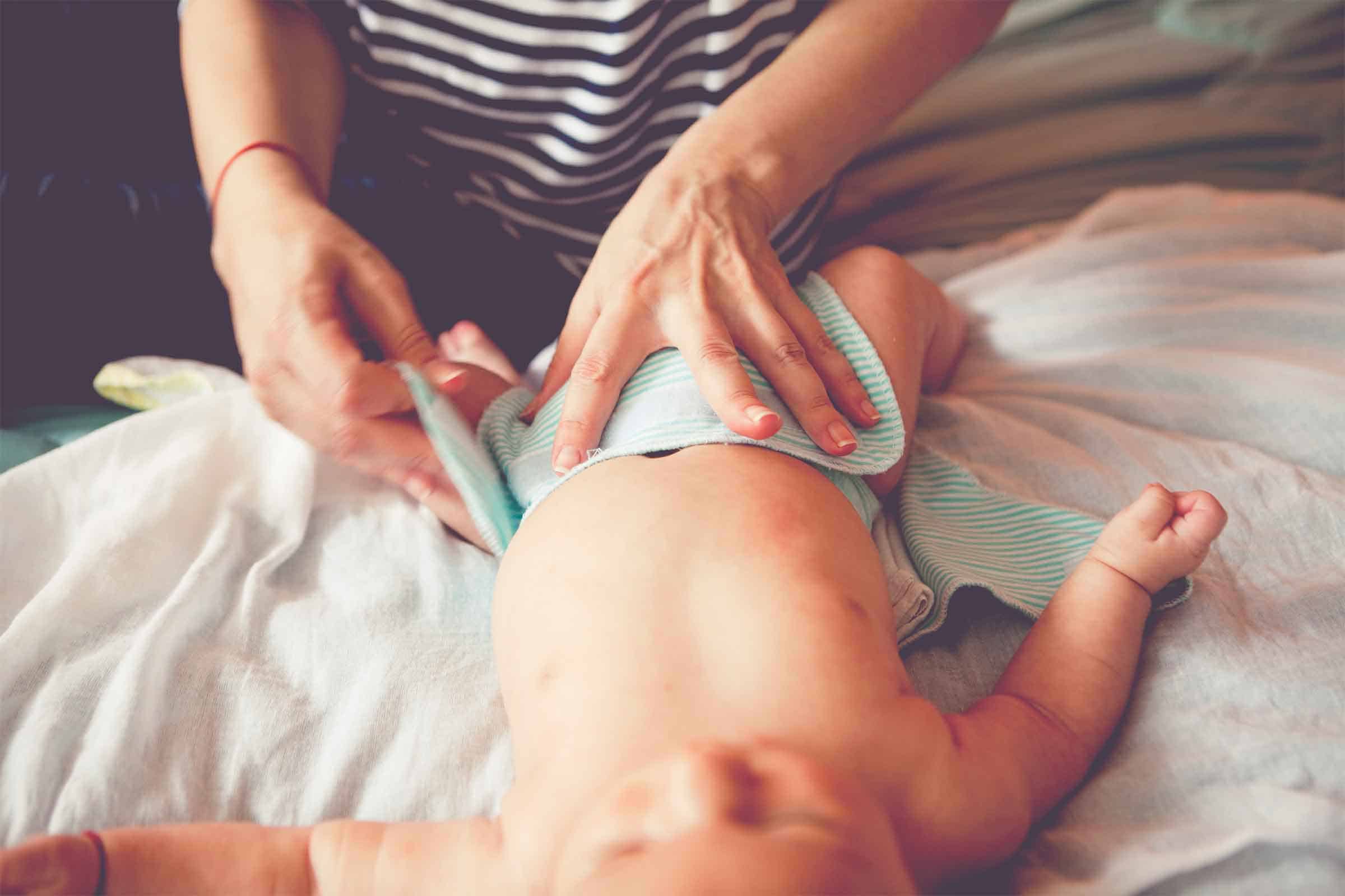 Mother changing her Baby Diaper