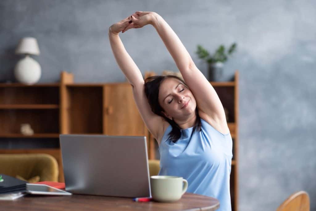 5 Effective Stretching Exercises You Can Do While Working From Home 6 woman doing some stretching exercises in home office